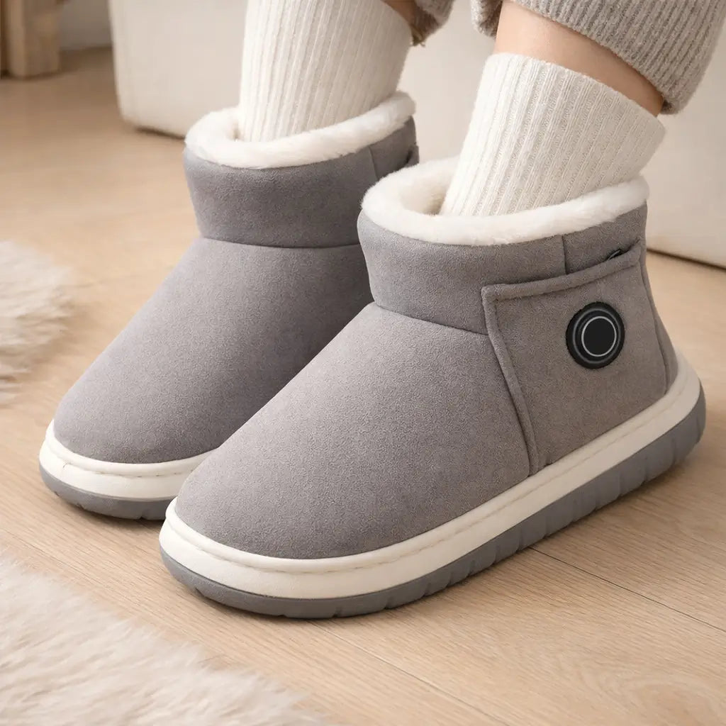 Grey rechargeable heated indoor boots worn with cozy socks