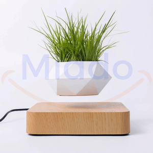 Witte zwevende pot met groen gras op lichtbruine basis.