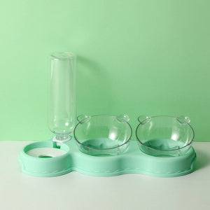 Groene voedertray met voerbakken en waterdispenser.