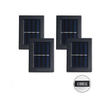 Vier zonnepaneel buitenlampen in een rij op een witte achtergrond.