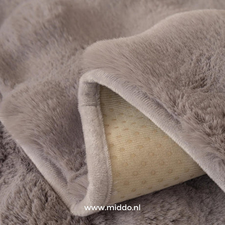 Detail van de antislip achterkant van een grijze meubelhoes